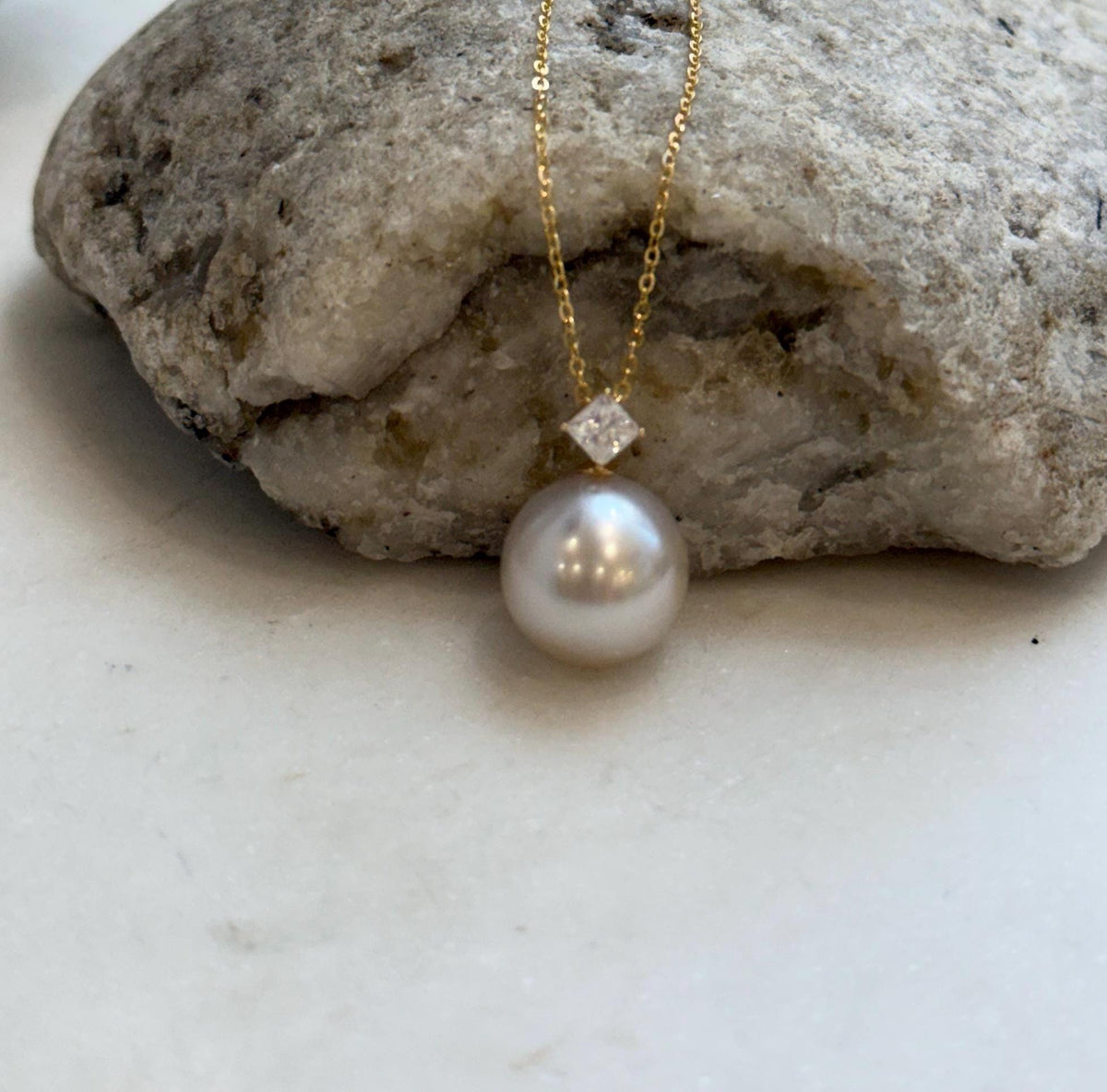 Luxury champagne pearl pendant accented with sparkling Moissanite and 18K gold.
