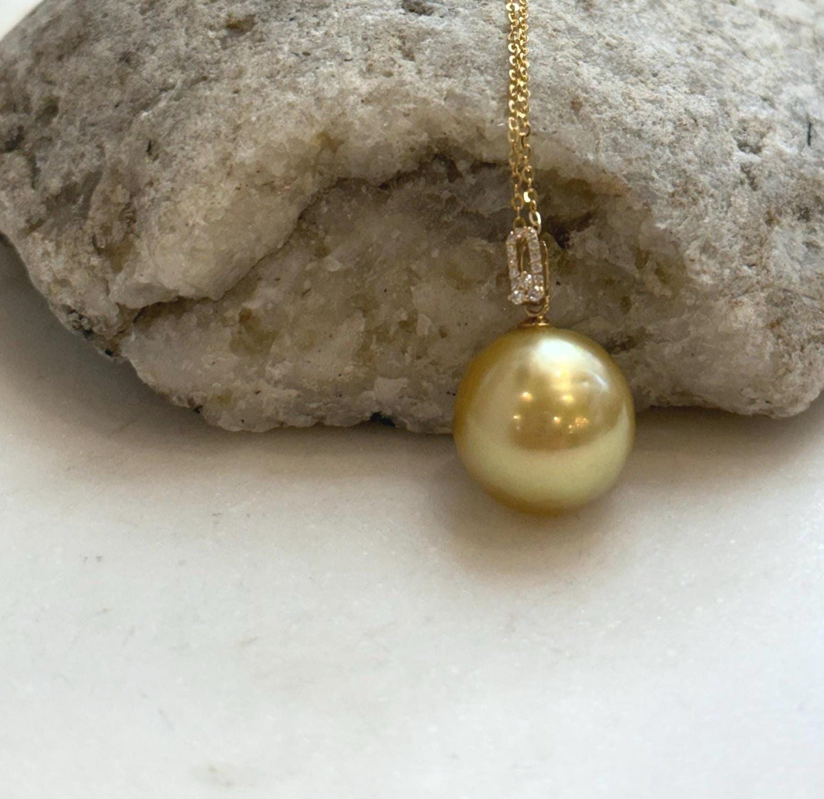 Large South Sea golden pearl jewelry with deep tea tone and reflective luster.