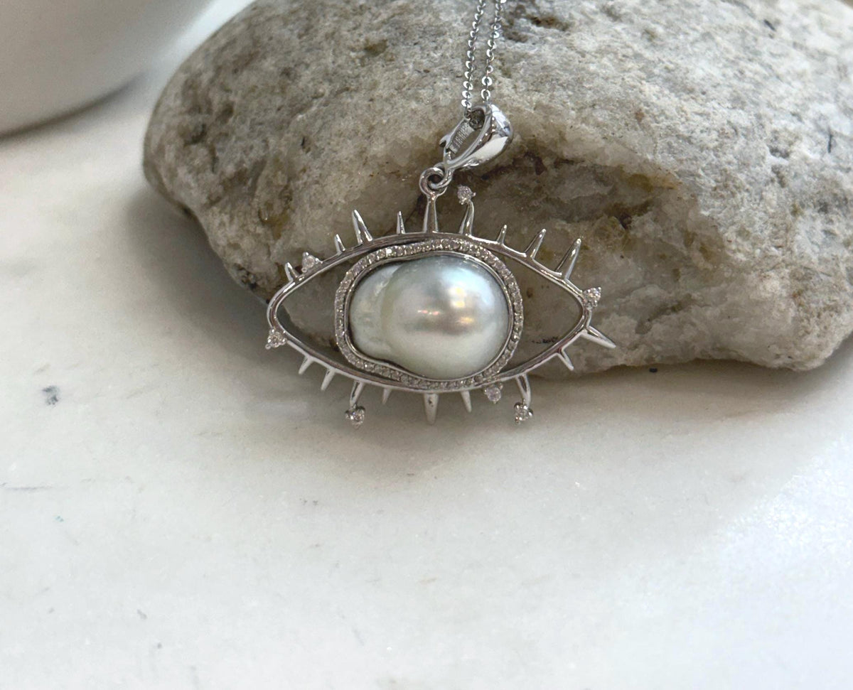 Genuine South Sea saltwater pearl set in a unique silver eye pendant design