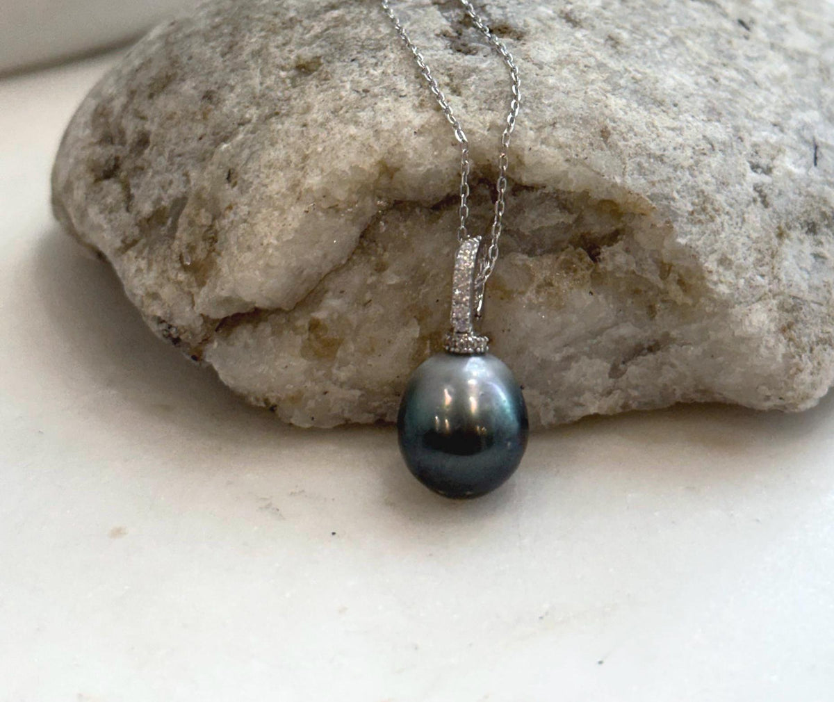 Genuine Tahitian saltwater pearl necklace featuring a lustrous round pearl and sterling silver setting.
