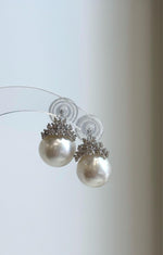 Round white ocean pearl earrings with elegant sterling silver crown tops