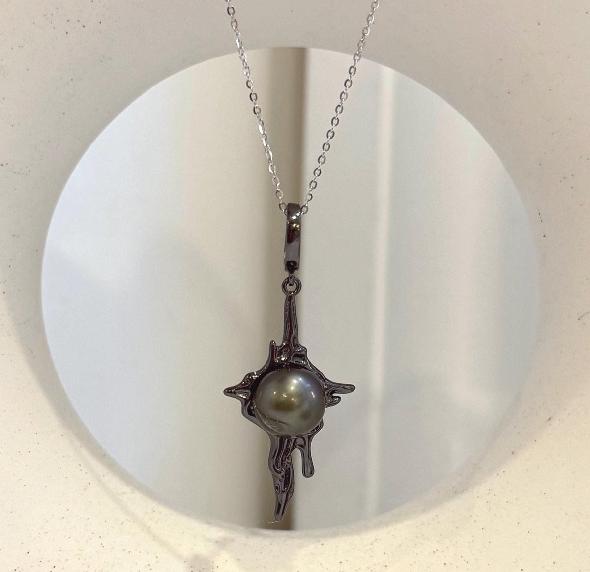 Tahitian black pearl lava pendant with extreme luster and copper setting