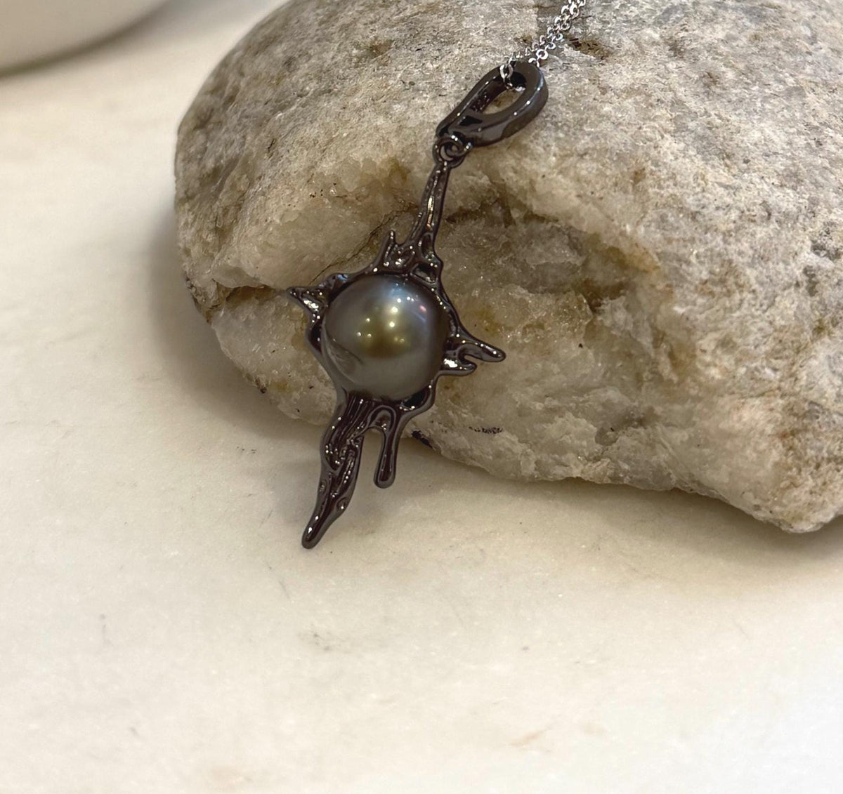 Black Tahitian ocean pearl pendant with organic lava inspired copper design