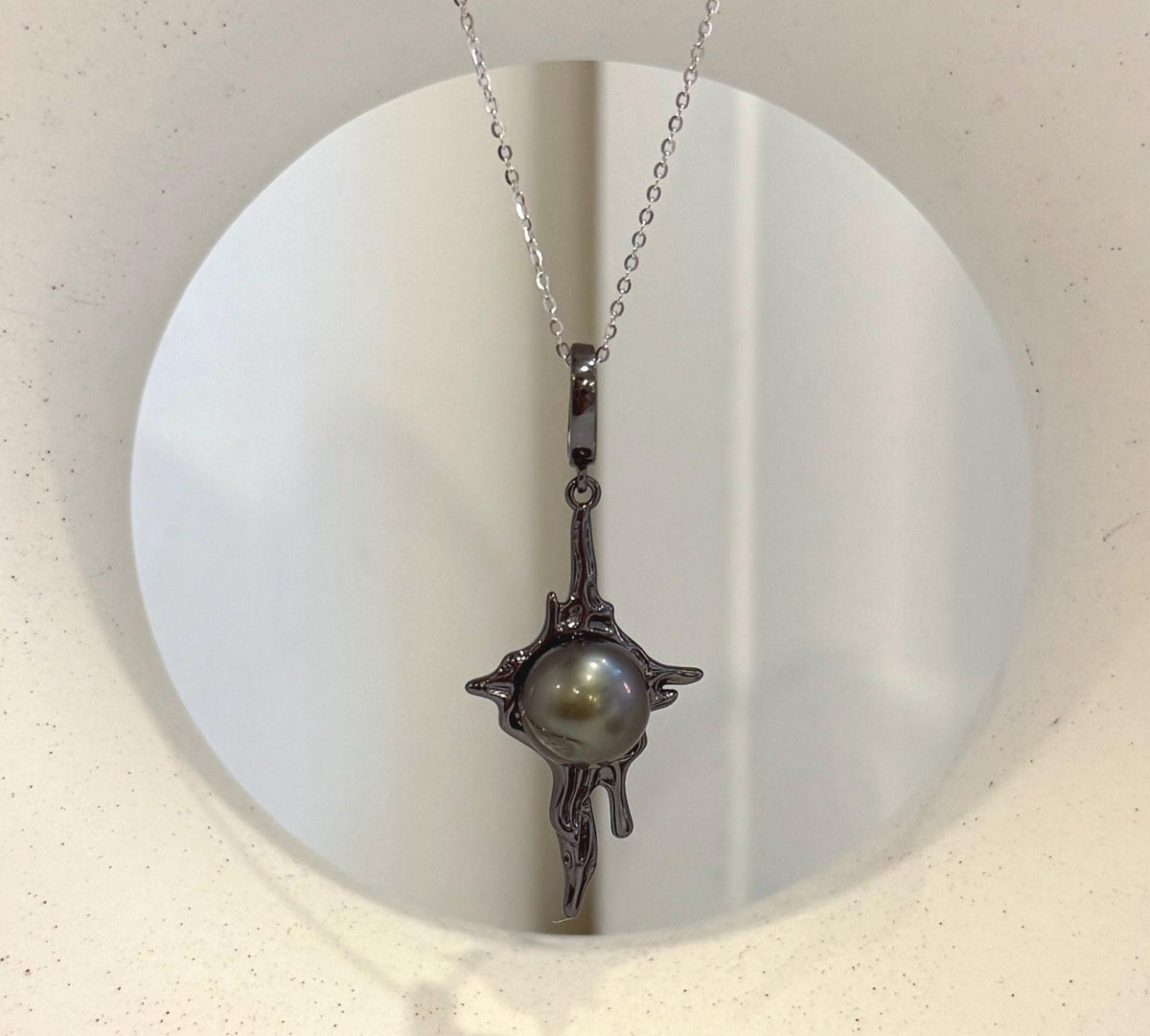 Tahitian pearl molten lava pendant featuring a lustrous black saltwater ocean pearl