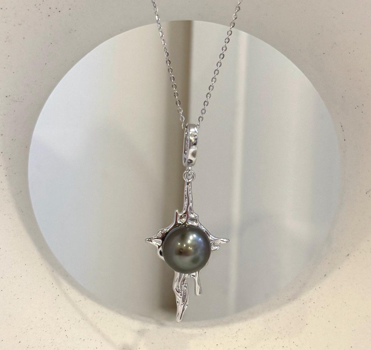 Peacock hunter Tahitian ocean pearl pendant with organic lava inspired copper design