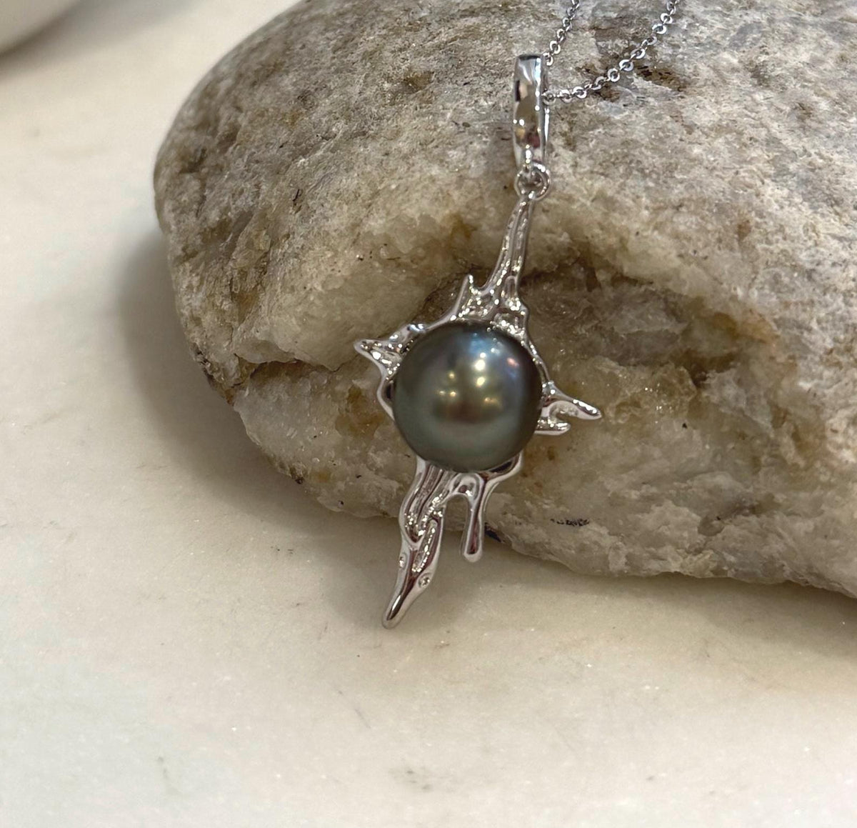 Tahitian pearl molten lava pendant featuring rich peacock hunter color and extreme luster