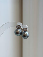Modern silver-grey pearl earrings with sparkling geometric accents