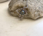 Platinum color Tahitian ocean pearl pendant in a creative eye-shaped copper setting