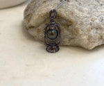 Extreme luster Tahitian ocean pearl set in an ornate vintage lantern pendant
