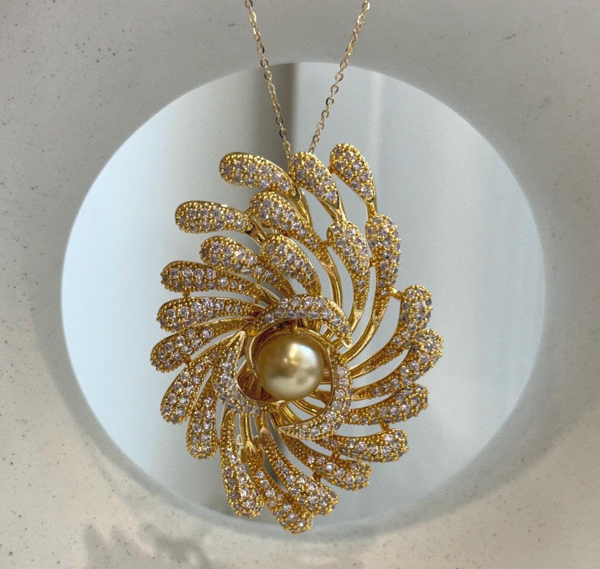 Genuine golden pearl set in a sparkling black and gold statement brooch