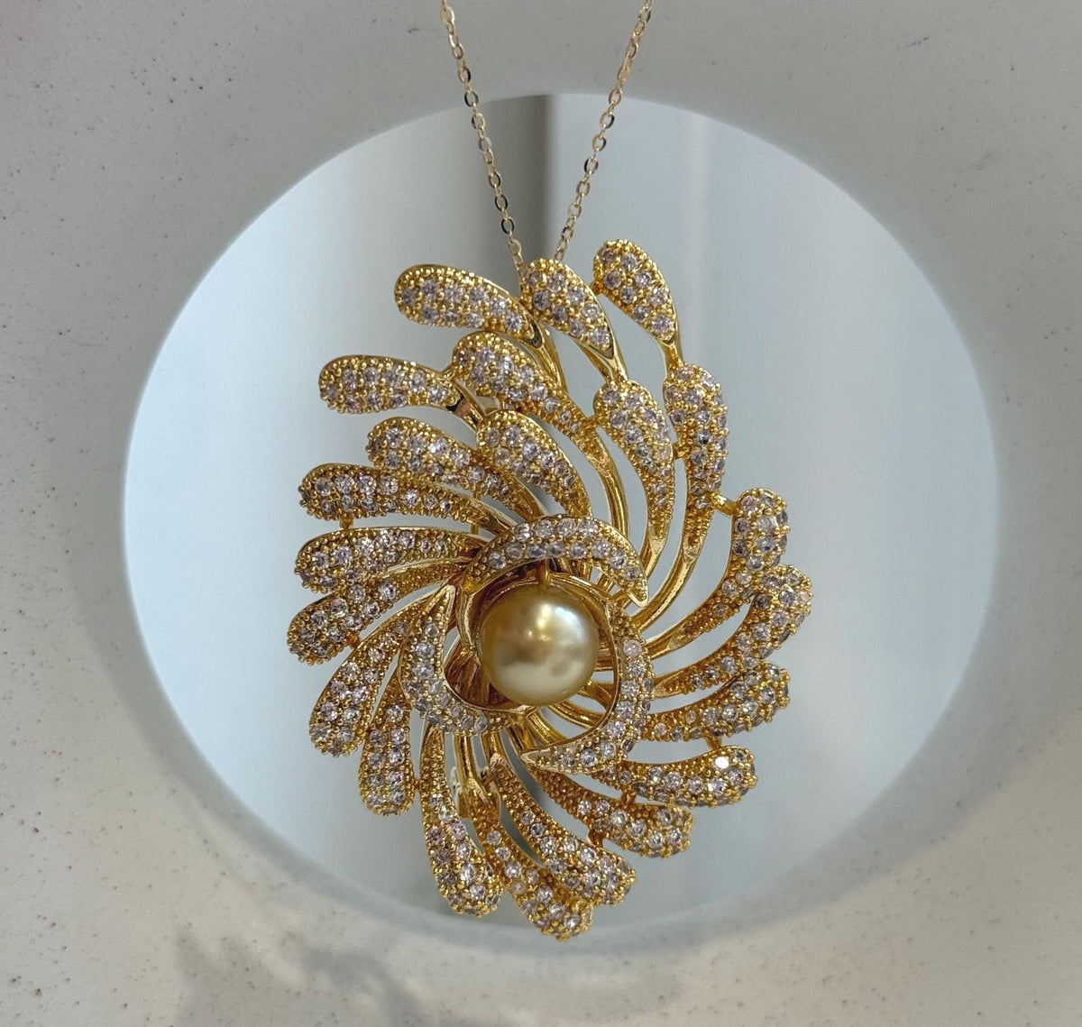 Sparkling statement brooch decorated with a rich golden South Sea pearl