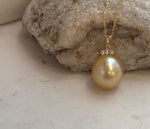 Genuine golden South Sea saltwater pearl pendant accented with sparkling moissanite and crafted in 18K real gold.