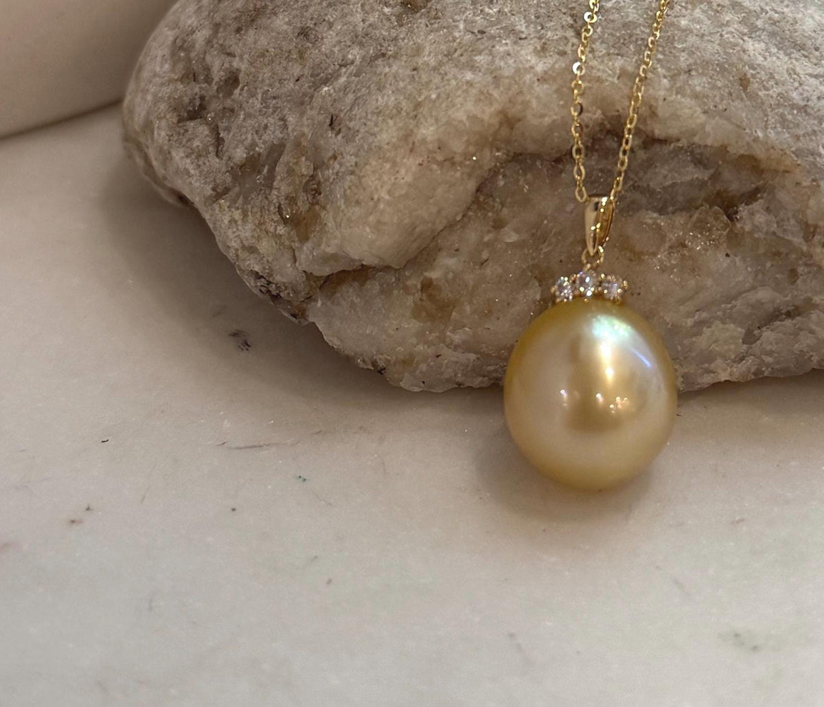 Genuine golden South Sea saltwater pearl pendant accented with sparkling moissanite and crafted in 18K real gold.