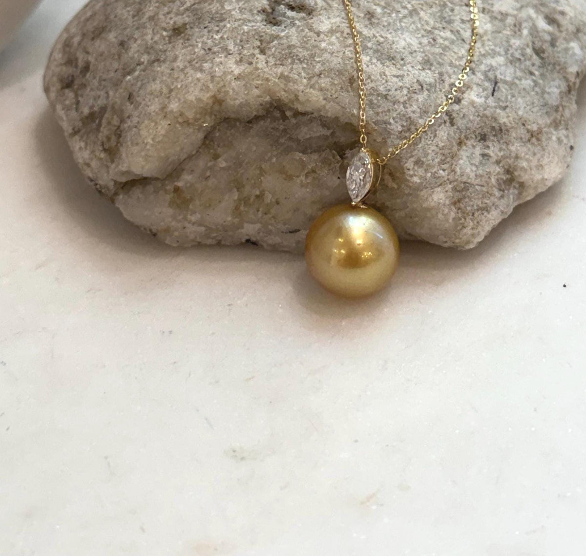 Large South Sea golden ocean pearl pendant with warm deep tea tones, mirror shine and elegant moissanite detail.