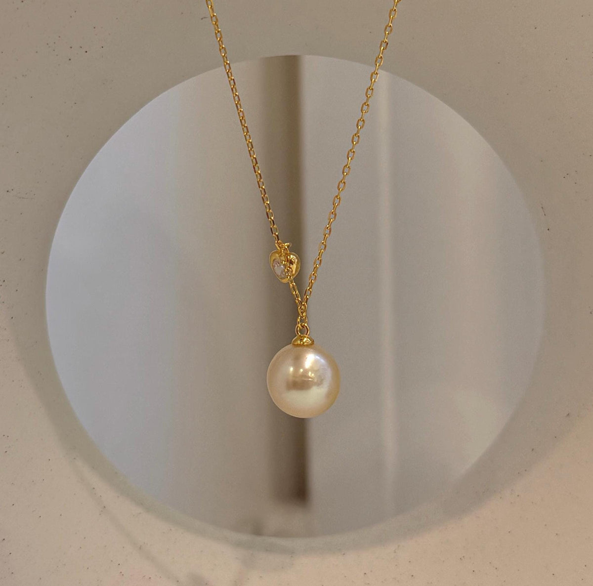 South Sea golden iridescent pearl pendant necklace featuring a genuine saltwater pearl with beautiful reflective luster.