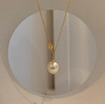 South Sea golden iridescent pearl pendant necklace featuring a genuine saltwater pearl with beautiful reflective luster.