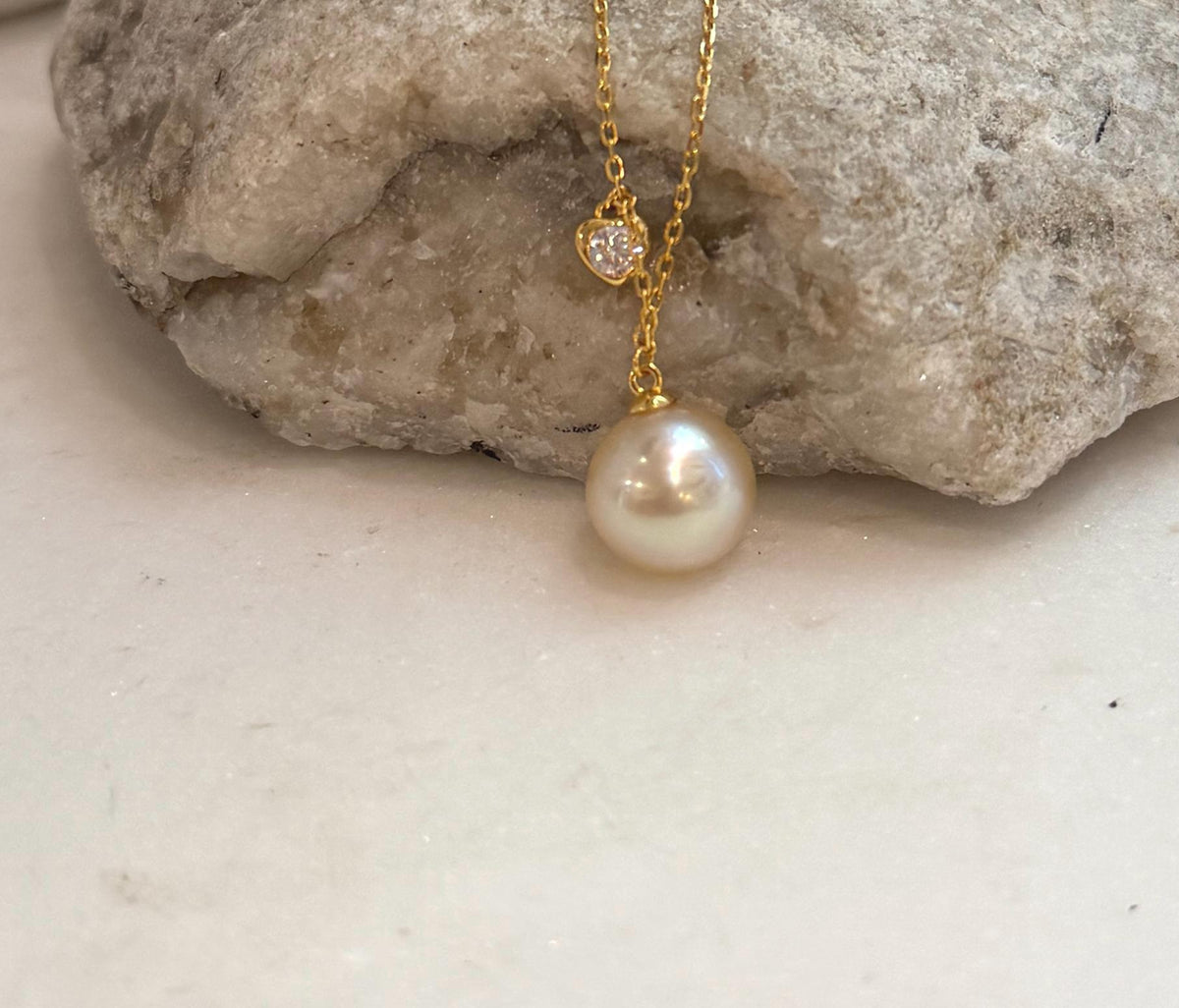 Fine South Sea saltwater pearl pendant with warm golden iridescent tones and an elegant sterling silver chain.