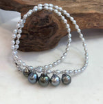 Detail of the dark Tahitian pearls beside the smaller white pearls.
