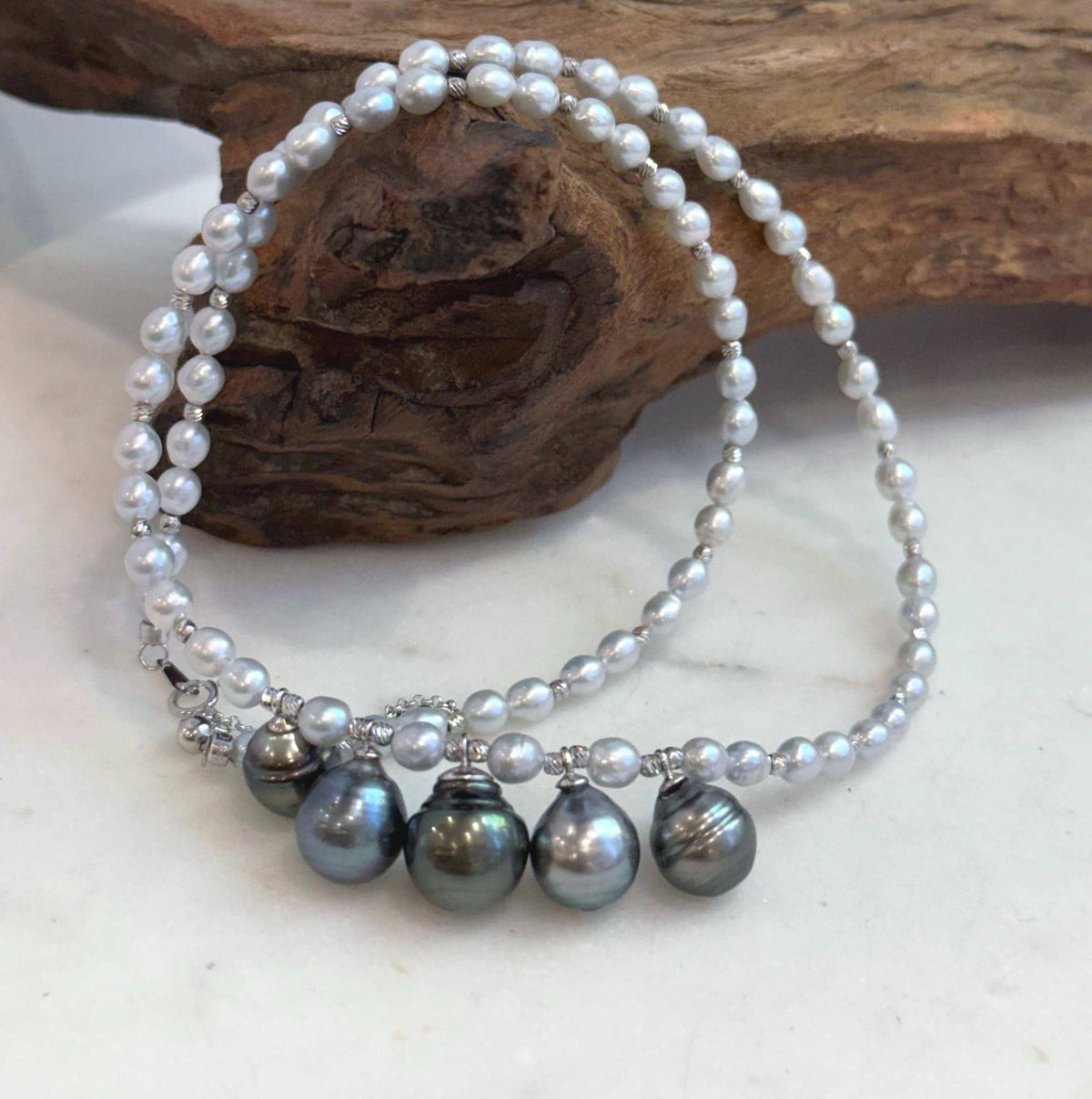 Detail of the dark Tahitian pearls beside the smaller white pearls.