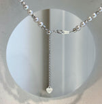 Close-up of the central South Sea pearl and its metallic luster.