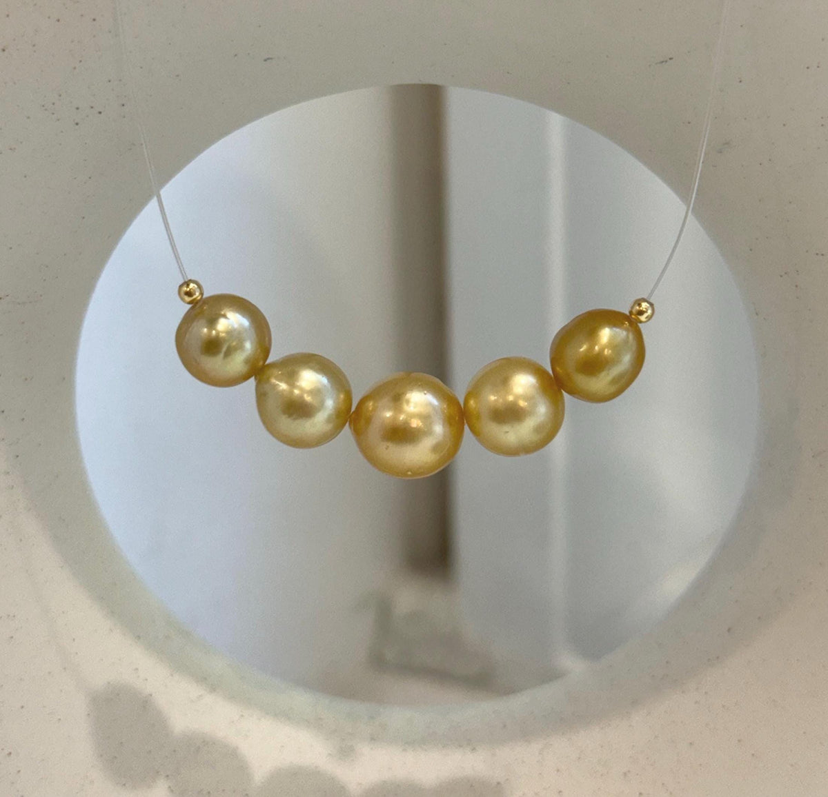 Front view of the five-pearl smile necklace.