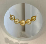 Golden pearls showing subtle differences in their natural tones.