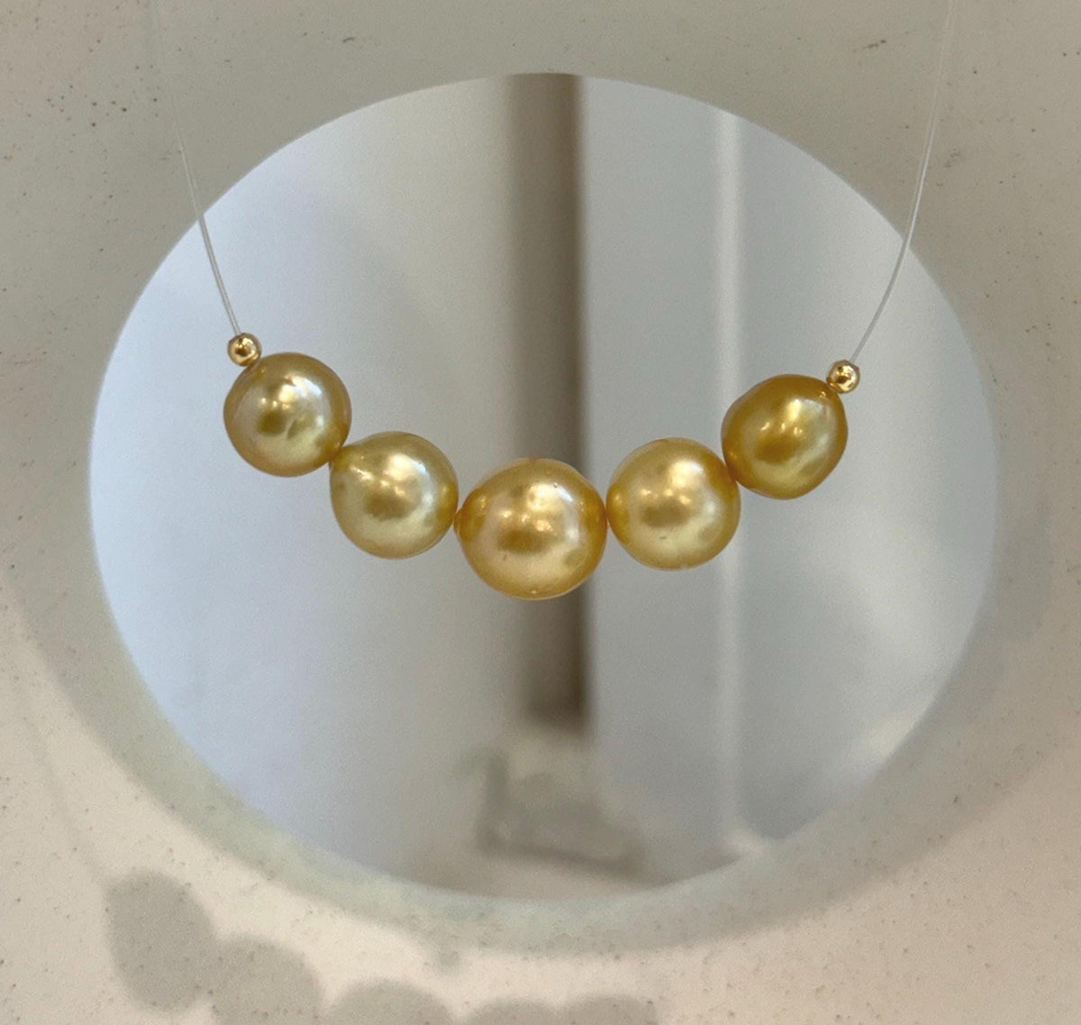 Golden pearls showing subtle differences in their natural tones.