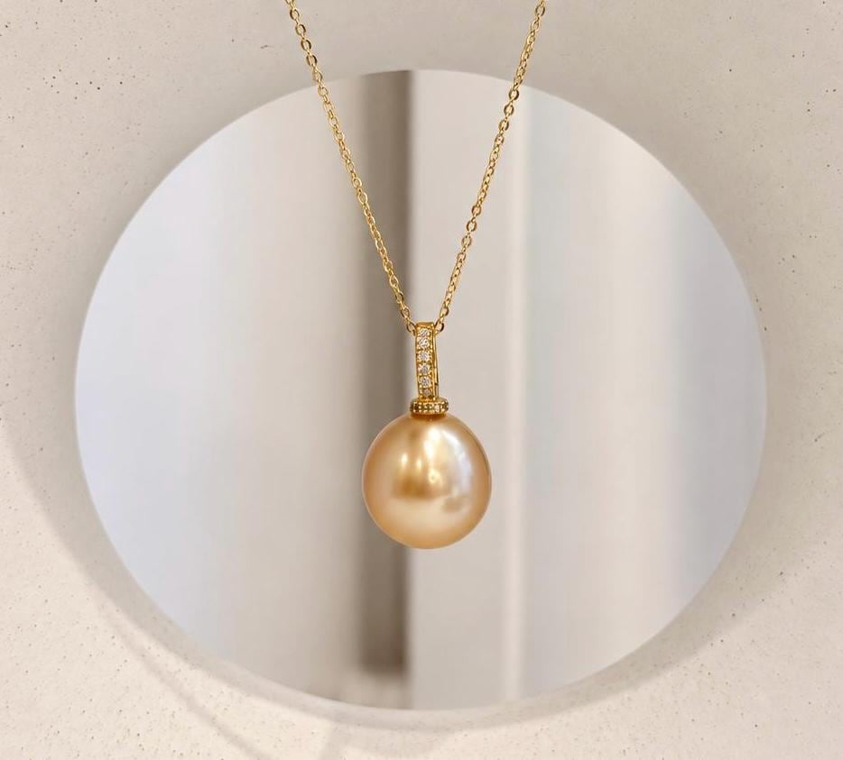 Genuine ocean pearl jewelry featuring a deep tea gold South Sea pearl and sterling silver pendant setting