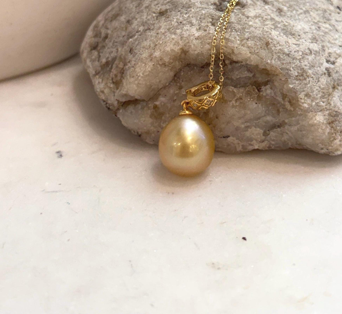 Genuine saltwater South Sea golden pearl pendant with rich deep tea gold color and brilliant luster.