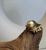 South Sea golden pearl with a highly reflective surface set in a star-design S925 silver ring with gold plating.