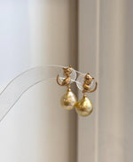 Deep tea golden South Sea pearl cat earrings with bright natural shine and detailed sterling silver setting.
