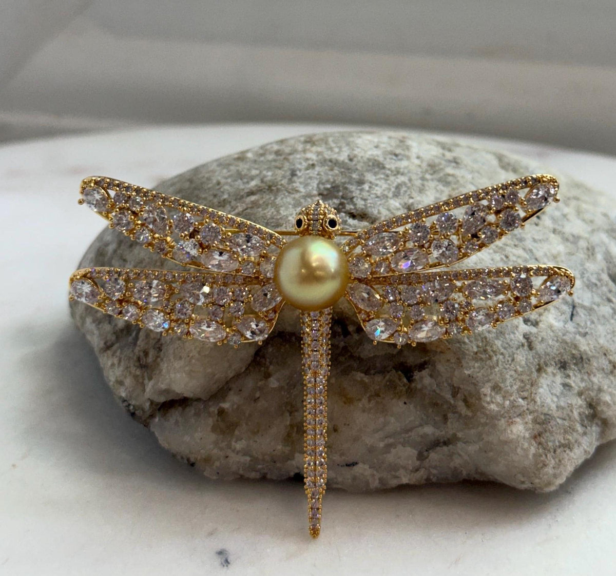 Two-in-one dragonfly jewelry featuring a genuine golden South Sea pearl, wearable as a brooch or pendant.