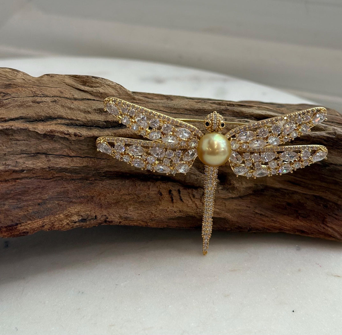 Deep tea golden saltwater pearl incorporated into a dragonfly brooch and pendant design.