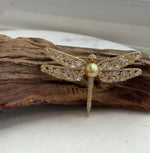 Dragonfly-inspired brooch featuring a lustrous golden South Sea pearl and a convertible pendant design.