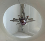 Close-up of the purple freshwater pearl’s mirror-like luster.