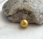 Front view of the deep tea golden pearl pendant.