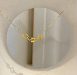 Detail of the pearl and its minimalist pendant setting.