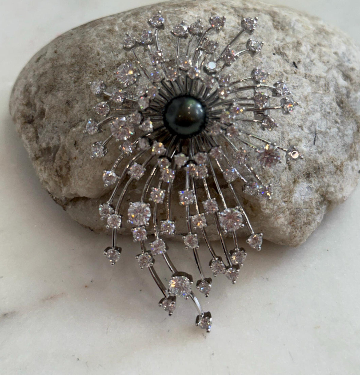 Close-up of the lustrous Tahitian pearl in the fireworks brooch pendant.