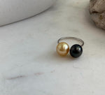 Minimalist open ring featuring a lustrous golden pearl beside a Tahitian pearl.