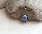 Genuine Ocean Mabe pearl pendant featuring rich purple iridescent color and highly reflective luster