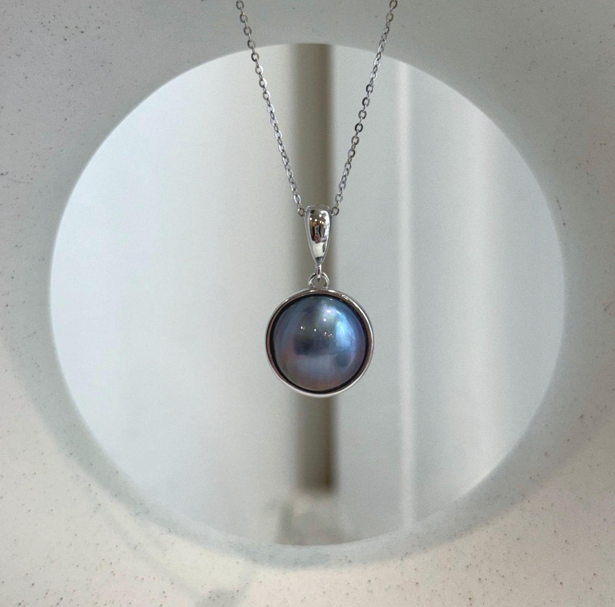 Genuine round Mabe pearl pendant necklace with luminous purple surface and sterling silver base