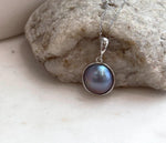Elegant Ocean Mabe pearl necklace featuring a smooth round pearl with vivid purple iridescence