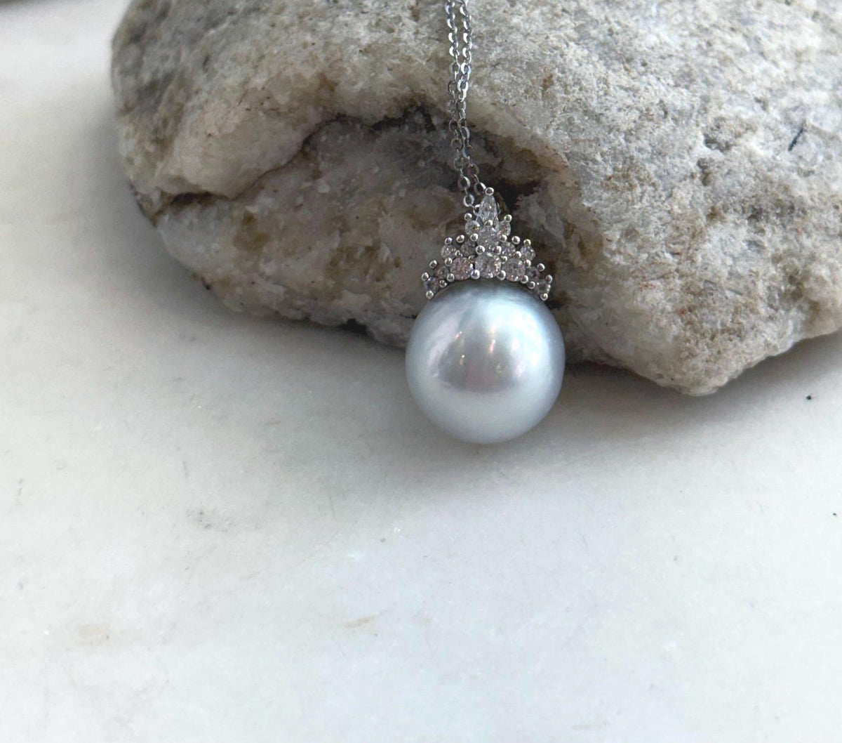 Genuine South Sea pearl necklace displayed on a white jewelry stand