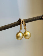 Side view showing the pearl drops and crystal accents on the hoops.