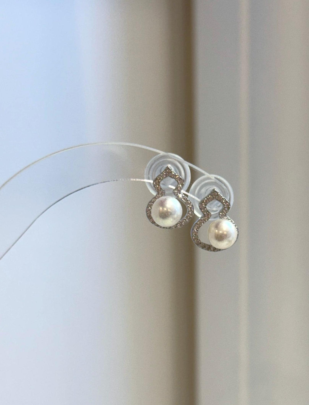 Elegant white pearl stud earrings with a gourd-inspired silhouette