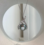 Peacock green Tahitian ocean pearl pendant featuring a natural organic Keshi shape.