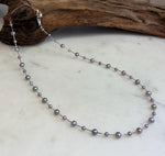 Detail of the smooth pearl surfaces and bright reflections on the satellite necklace