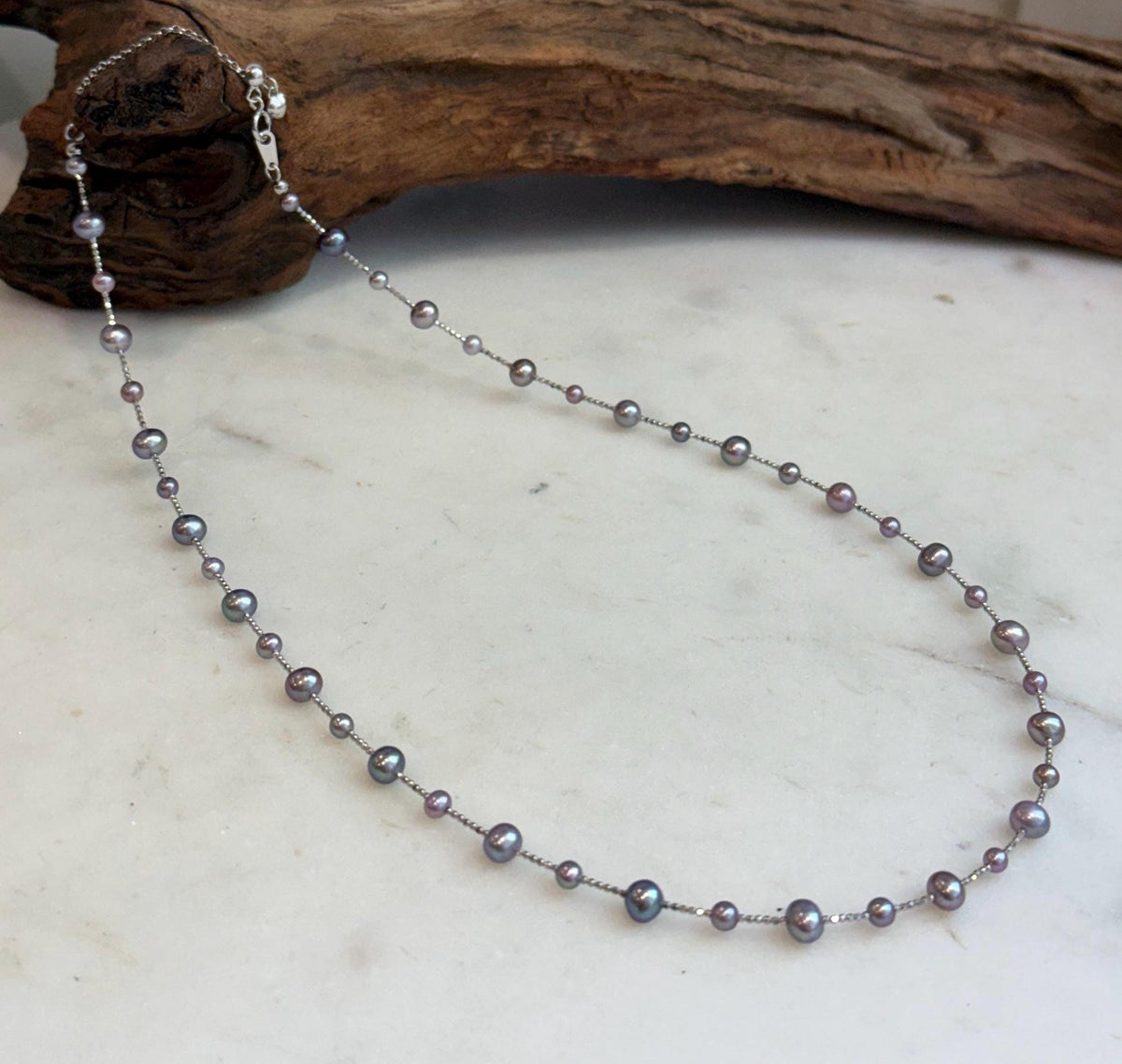 Detail of the smooth pearl surfaces and bright reflections on the satellite necklace