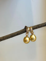 Golden South Sea pearl earrings photographed hanging side by side.
