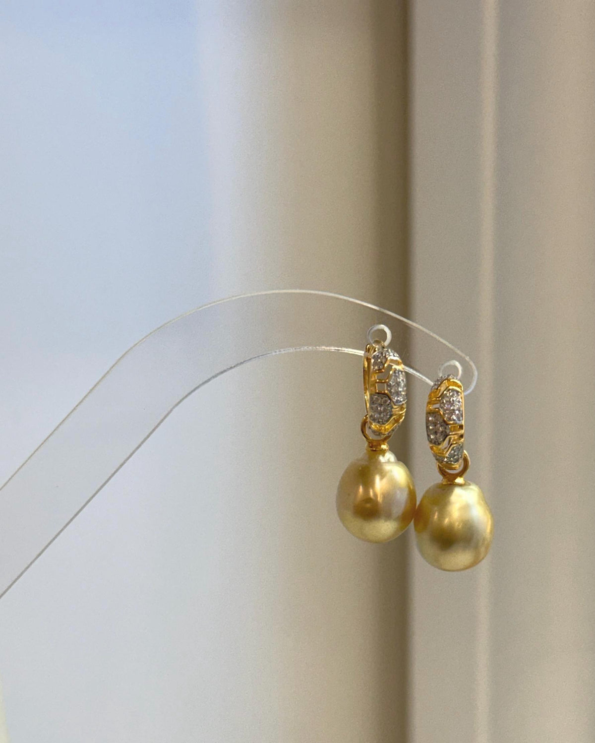 Golden pearls with soft natural variations in color and shape.